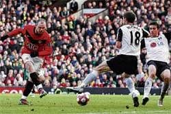 ON TARGET: Manchester Uniteds Wayne Rooney shoots to score past Fulhams Hughes in the English Premier League match on Sunday. REUTERS