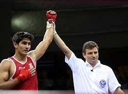 Indian boxer Vijender Singh (L) is declared winner against Tanzania's boxer Selemani Kidunda during semifinals of 75 kgs category at 5th Commonwealth Boxing Championship in New Delhi on Monday. PTI