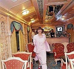 Happy Journey: A foreign tourist inside Golden Chariot on Southern Splendour trip which was flagged off from Yeshwantpur railway station in the City on Monday. DH Photo