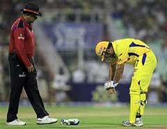 Chennai Super Kings M S Dhoni reacts in pain while batting against Kolkata Knight Riders during their Indian Premier League-3 match in Kolkata on Tuesday. PTI Photo