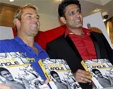 Shane Warne launching the book 'Wide Angle' written by Anil Kumble (R) in Bangalore on Wednesday. PTI