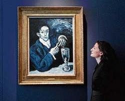 An employee poses for photographers next to the Portrait of Angel Fernandez de Soto  also known as The Absinthe Drinker by Pablo Picasso  at Christies auction house in London on Wednesday. REUTERS
