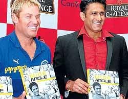 LENS VIEW: Royal Challengers Bangalore skipper Anil Kumble and Rajasthan Royals captain Shane Warne hold the formers book Wide Angle in Bangalore on Wednesday. DH photo