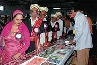 Kodava Sahithya Academy President Rani Machaiah and others having a look at the book exhibition held as part of Kodava Sahithya Samskrithika Mela in Ponnampet on Friday.  DH Photo