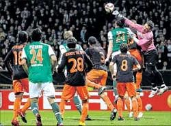 THWARTING DANGER: Valencia's goalkeeper Cesar Sanchez (right) punches away a cross during their Europa League last-16 match against Werder Bremen on Thursday. REUTERS