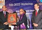 The Union Finance Minister Pranab Mukherjee being presented a painting by RBI Governor D Subbarao as OECD Deputy Secretary General Ambassador Richard A Boucher (right) during the inauguration of the International Workshop on Financial Literacy in Bangalore on Monday. PTI