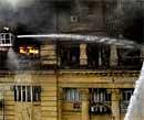 Firefighters spray water to douse fire at a building in Calcutta on Tuesday.AP