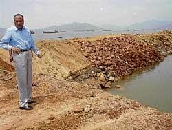 here is the spot S R Nayak, Chairman of State Human Rights Commission inspecting an  illegal jetty constructed by an ore company at the Belekeri Port, Ankola. DH photo