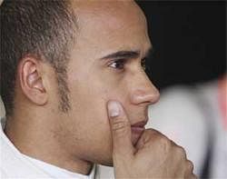 McLaren Formula One driver Lewis Hamilton of Britain talks to team mechanics during the first practice session at the Australian Formula One Grand Prix in Melbourne on Friday,. AP