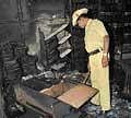 Police inspecting the burnt library at Dr Raj Katte on Padmanabhanagar Main Road in Bangalore on Saturday. DH Photo