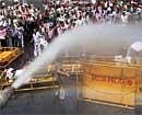 Police using water cannons to disperse BJP workers during a protest against price rise outside Delhi Secretariat on Monday. PTI