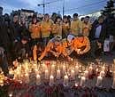 People light candles to pay tribute to victims of Monday's subway blasts in Lubyanka square, in Moscow on Wednesday. AP