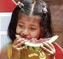 Savouring: Enjoying a cool slice of watermelon.