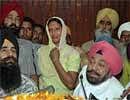 Ranjit Kaur, centre, wife of Dharampal one of the 17 Indians who have been sentenced death on charges of killing a Pakistani national in United Arab Emirates, sobs during a press conference in Jalandhar onThursday, AP