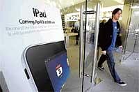 Showtime: A man walks out of an Apple Store in Palo Alto, California. A whole lot of people are willing to plunk down their money for an iPad, hoping it will turn out to be the missing link in their digital lives. AP