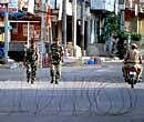Security personnel patrolling the streets in curfew-bound old city of Hyderabad on Thursday. PTI