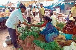 CMC member Hemavathi selling vegetables in Chikmagalur market. dh photo
