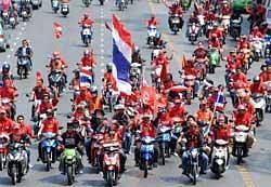 Red Shirts supporters of ousted premier Thaksin Shinawatra wave Thai national flags as they gather during anti-government protests in Bangkok on April 3, 2010. AFP