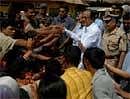 Home Minister P. Chidambaram (2R) shakes hands with villagers during a visit to Lalgarh, some 130kms west of Kolkata, on  Sunday. AFP