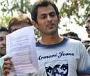 Pakistani cricketer Shoaib Malik holds a press release as he addresses the media outside Indian tennis player Sania Mirza's house in Hyderabad on Sunday. AP