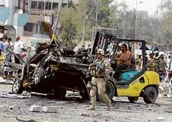 An Iraqi soldier inspects the site of a car bomb attack near the Iranian Embassy in Baghdad, Iraq, on Sunday. AP