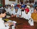 Union Minister of State for External Affairs Parneet Kaur (L) interacting with family members of 17 Indians who have been sentenced to death by a UAE court on charges of killing a Pakistani citizen, in Patiala on Sunday. PTI