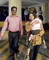 Placido Carvalho, left, leaves with his wife and child from the Goa State Childrens Court in Panaji on Monday. Carvalho, is facing charges of culpable homicide, sexual assault and  destroying evidence in the 2008 death of British teenager Scarlett Keeling. AP
