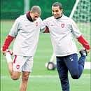 Arsenal's Gael Clichy (left) and Theo Walcott during their training session in London on Monday. AP