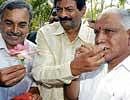 sweet success Minister B N Bachegowda giving sweets to Chief Minister B S Yeddyurappa on BJPs victory.  DH photo