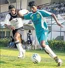 Golden Threads Binu Vijayan (right) gets the better of Titanium            Travancores  Tinson Justin in their I-League Second Division clash on Tuesday. DH Photo