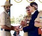 Chief Secretary S V Ranganath presenting the 2009-10 Chief Ministers gold medal to constable and fingerprint expert N Somashekar at the SP office in Kolar recently.