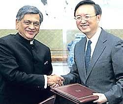 Chinese Foreign Minister Yang Jiechi, right, shakes hands with his Indian counterpart S M Krishna at Diaoyutai State Guest House in Beijing on Wednesday. Reuters