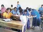 Mass copying in progress at an SSLC examination centre at Nandgaon village in Athani taluk in Chikodi educational district on Wednesday. dh photo