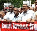 CPI-M General Secretary Prakash Karat (centre), CPI leaders A B Bardhan (third from left), A Raja (second from left) and left-wing activists march during a demonstration against price rise in New Delhi on Thursday. AFP