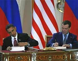 U.S. President Barack Obama, left, and his Russian counterpart Dmitry Medvedev, right, sign  the New START nuclear arms reduction treaty at Prague Castle on Thursday. AP