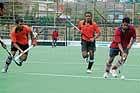 Players of MEG and Central Excise teams in action at the State-level Super Division Hockey Leage at Madikeri on Thursday. DH Photo