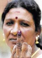 A Sri Lankan voter shows her inked finger after voting at a polling station in Colombo on Thursday. AFP
