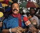 Sri Lankan President Mahinda Rajapaksa talks to media after casting his vote for parliamentary elections in his home town village Madamulana on Thursday. AP