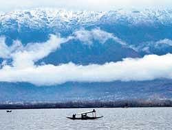 Snow covered mountains are seen in the backdrop of the Dal Lake in Srinagar. File photo. AP