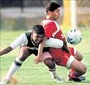 Tinson Justin (left) of Titanium tries to check Mohd Aslam of State Bank of Travancore in the I-League second division in Bangalore on Friday. DH photo