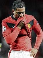 crestfallen Patrice Evra is a picture of dejection after his team Manchester United bowed out of the Champions League last week. AFP