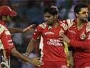 Royal Challengers Bangalore's Vinay Kumar (C) is congratulated by team mates for taking the wicket of Kolkata Knight Riders' skipper Sourav Ganguly during their IPL T20 match at Chinnaswamy stadium in Bangalore on Saturday. PTI