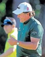 HOW IS THAT? Phil Mickelson gives the thumbs up after his eagle on the 14th hole during the third round of the Masters golf tournament in Augusta on Saturday. AP