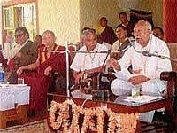 RSS former Sarsanghchalak K S Sudarshan speaking at a religious lecture programme organised at the Bailukuppe Tibetan Refugee Camp near Kushalnagar on Thursday. Medical Education Minister Ramachandre Gowda looks on. DH Photo