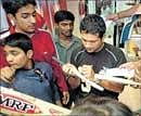 Craze: Sachin Tendulkar autographs on a bat.