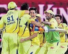 Joy unbounded: Chennai Super Kings players mob skipper MS Dhoni after he led them to the semifinals of IPL III at Dharamsala on Sunday. AFP