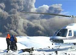 Film crew working for National Geographic publication set-up on southern Icelands Eyjafjallajokull glacier after landing on the glacier, close to the volcanic eruption, on Sunday.  AP