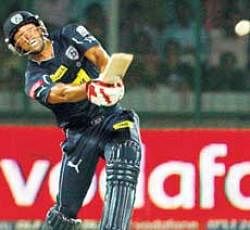 In fine flow:  Deccan Chargers Andrew Symonds smashes a six en route to his fifty against Daredevils on Sunday. PTI