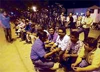 Mediapersons wait outside Prime Minister Manmohan Singhs residence for information on the fate of Shashi Tharoor in New Delhi on Sunday. PTI