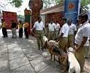 Sniffer dogs and police personnel keep vigil of the Chinnaswamy stadium after two crude bombs were found near it, in Bangalore on Sunday